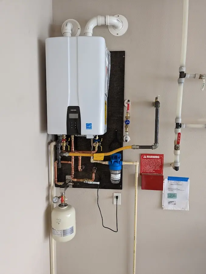 Professional plumber installing copper piping in a West York home